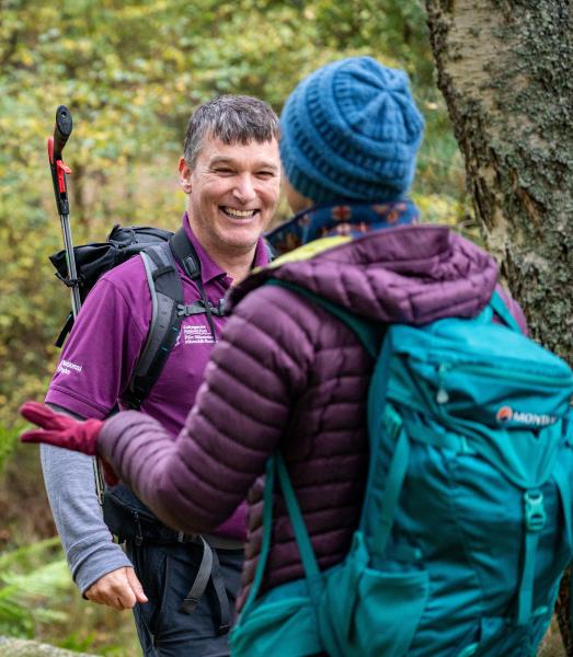 Friendly seasonal ranger meets a member of the public while out on patrol.