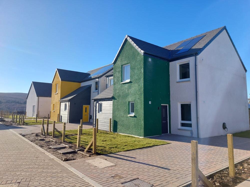 Affordable housing at Tomintoul with colourful painted fronts.