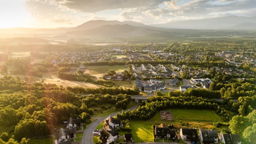 Aerial view over the north end of Aviemore looking east at sunrise.