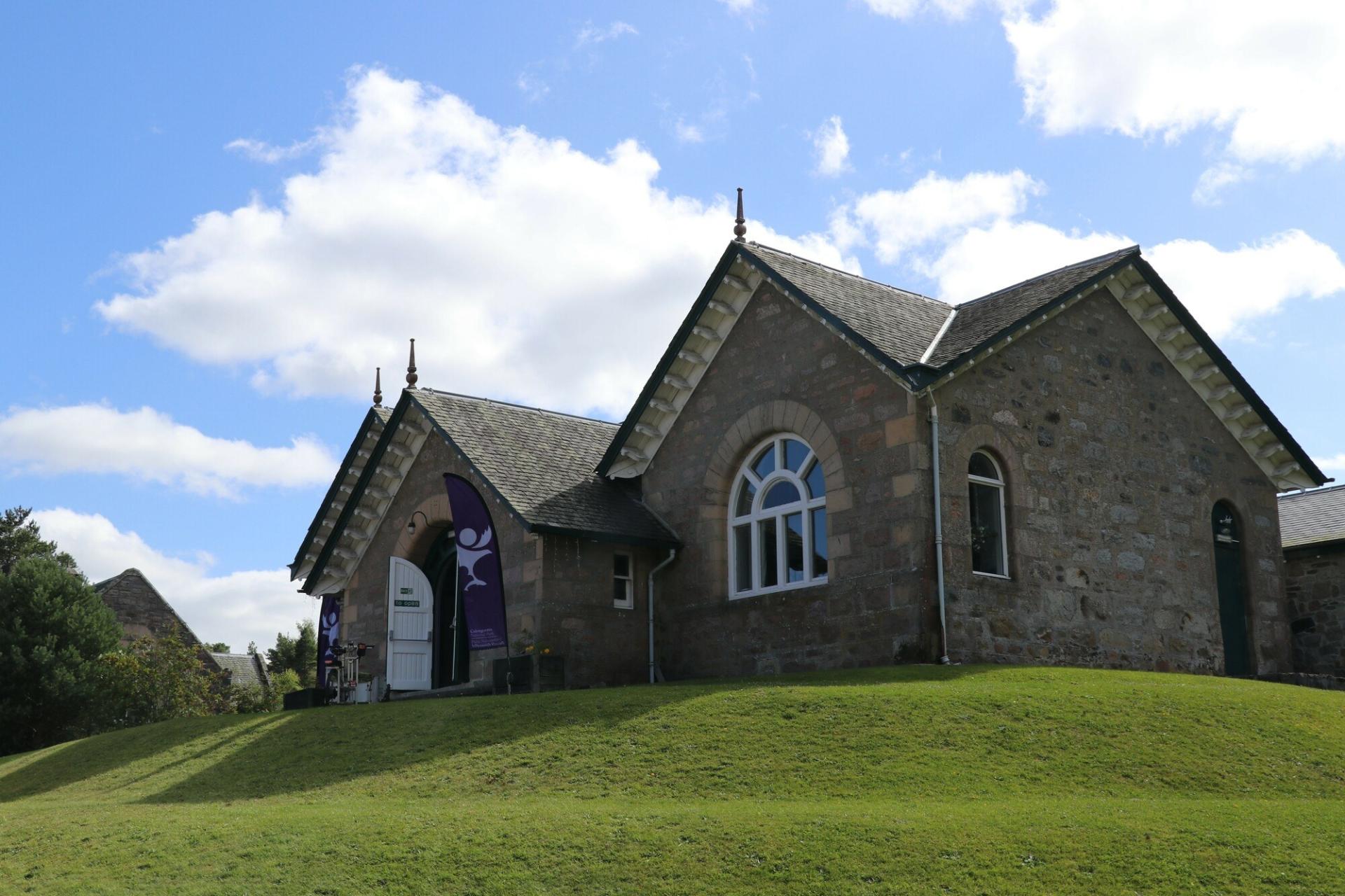 Carrbridge village hall with Cairngorms National Park flags outside for a Cairngorms 2030 drop in event.