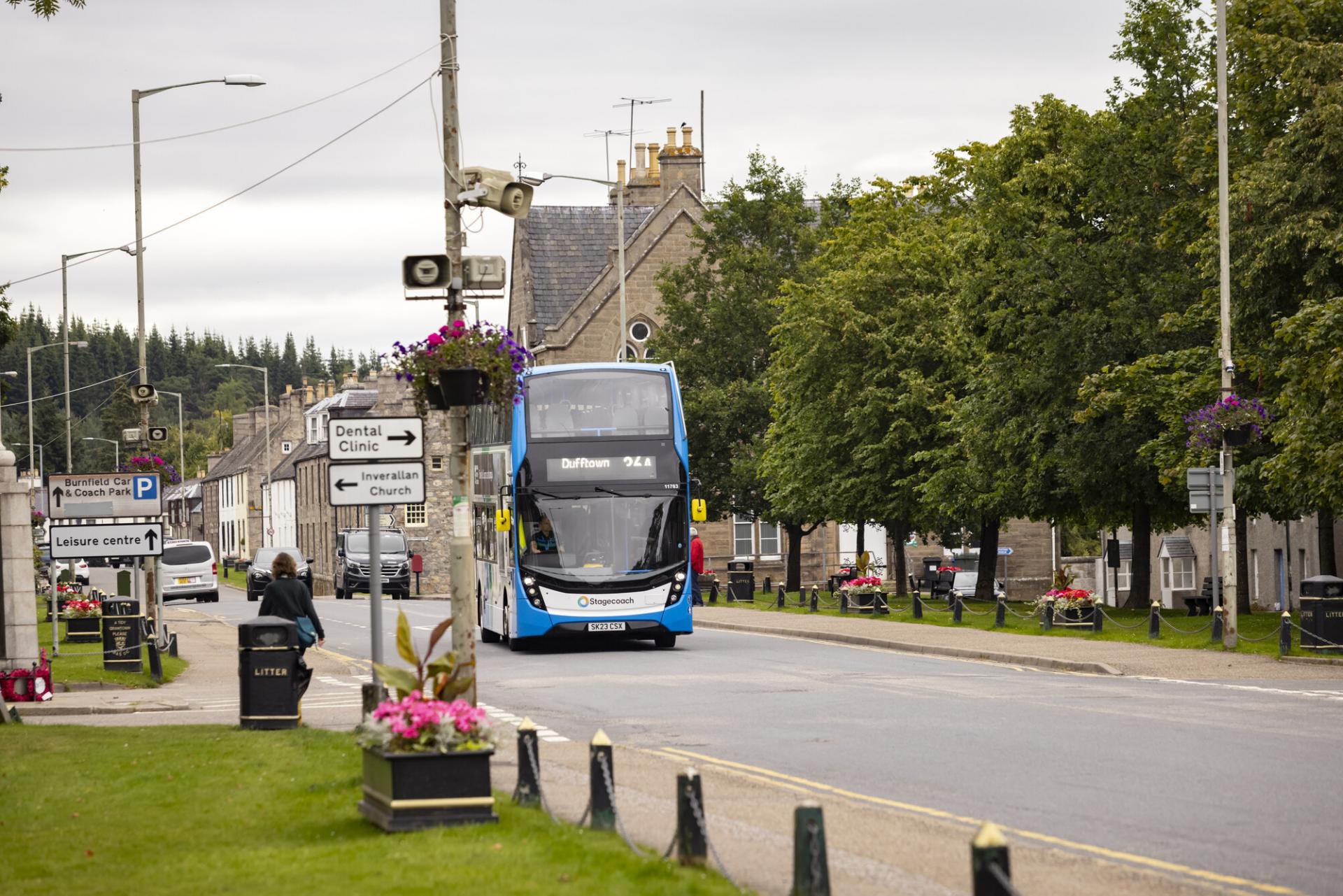 A street scene with a double decker bus.