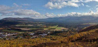 Aerial view of Aviemore and Cairngorm Mountains from Craigellachie Nature Reserve.