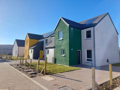 Affordable housing at Tomintoul with colourful painted fronts.