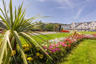 Two people riding bikes through the Gynack Gardens, Kingussie