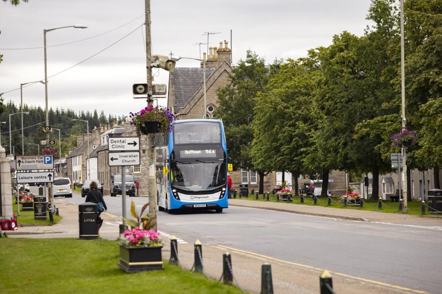 A street scene with a double decker bus.