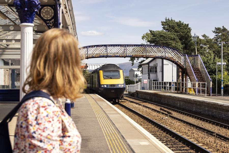 Person waiting for the train pulling into Kingussie station.