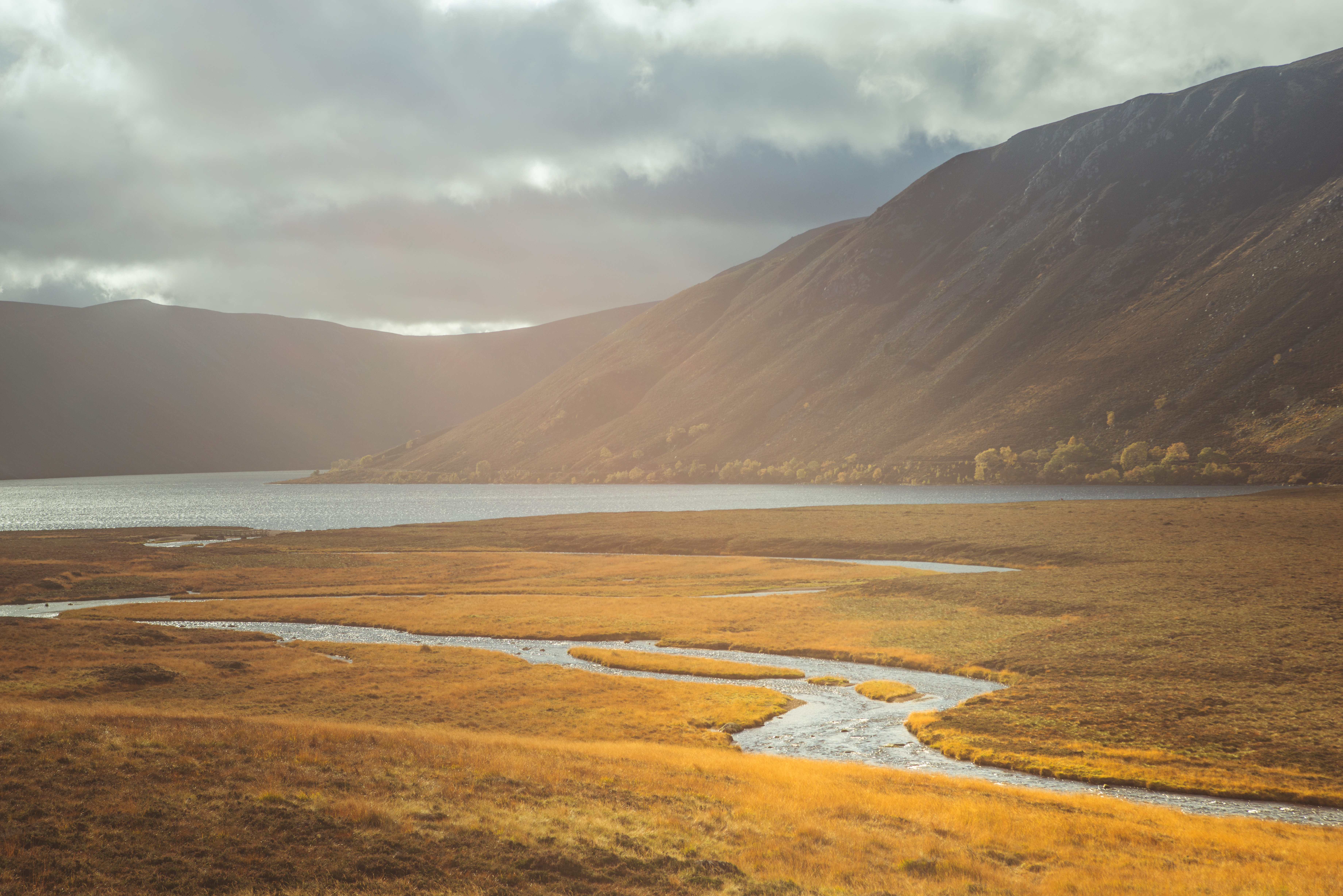 Sunlight over a river and loch