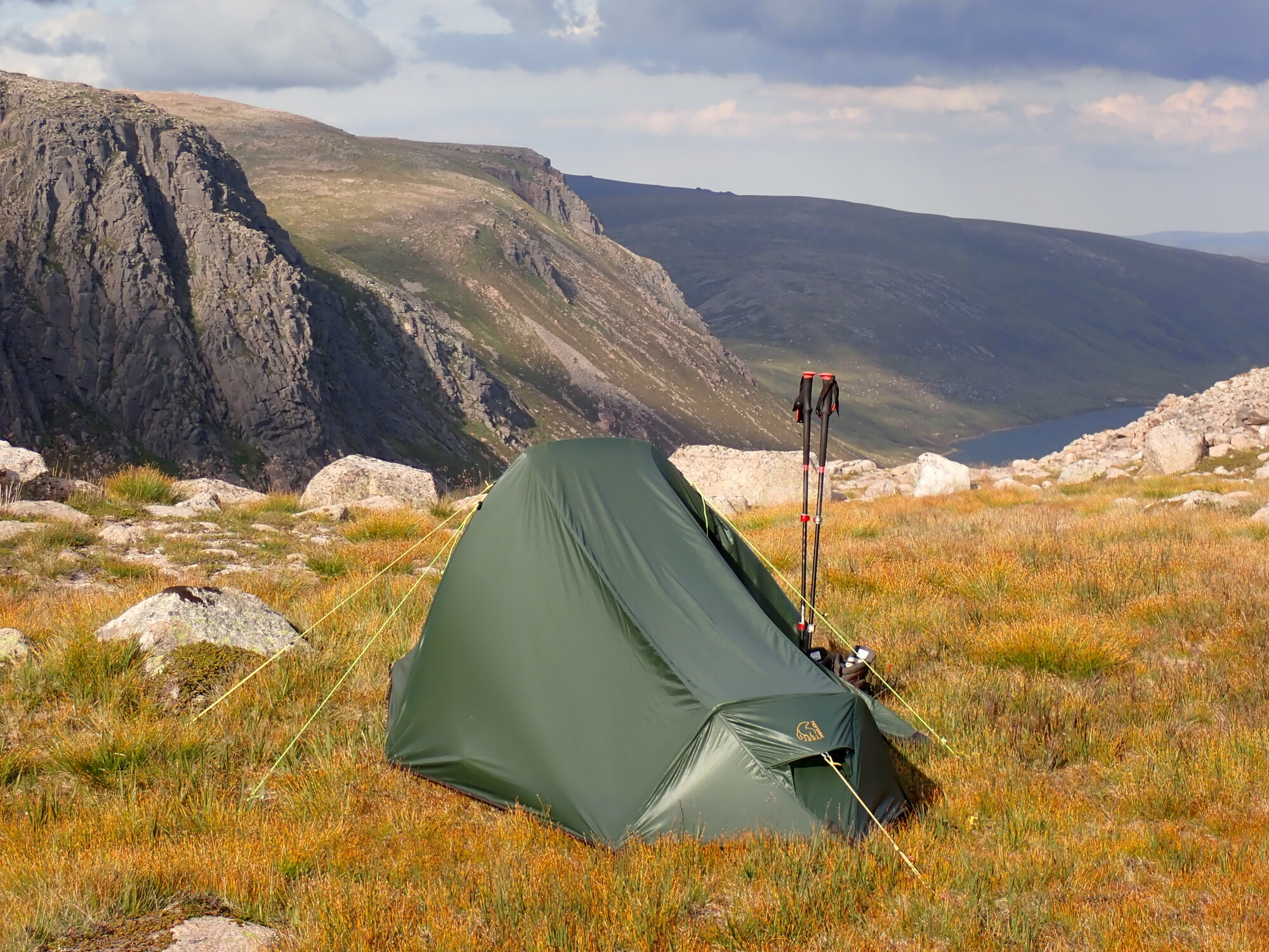 Tent and walking poles in the mountains above Loch Avon.