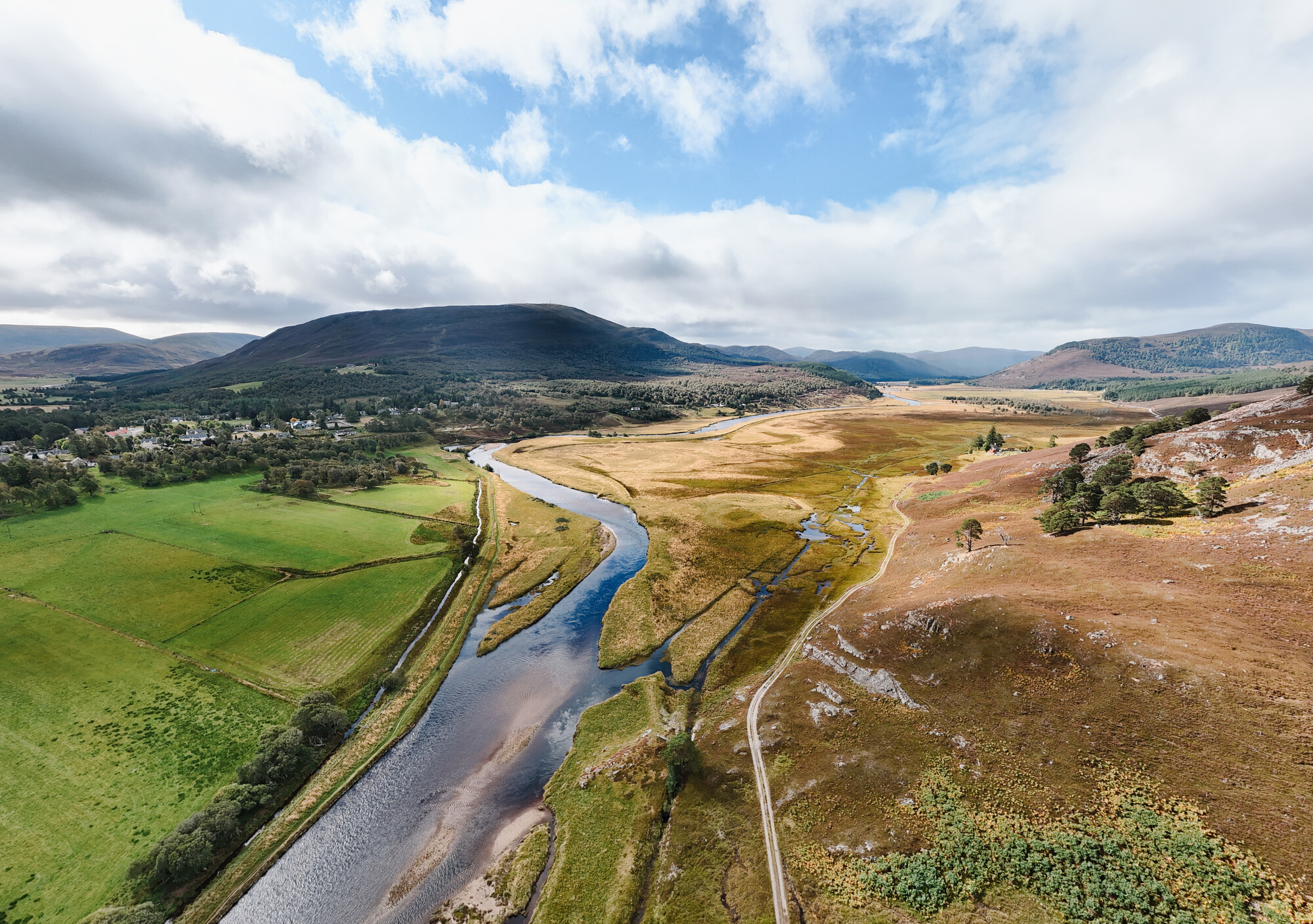 Aerial view of the River Dee and surrounding wetland , fields and mountains