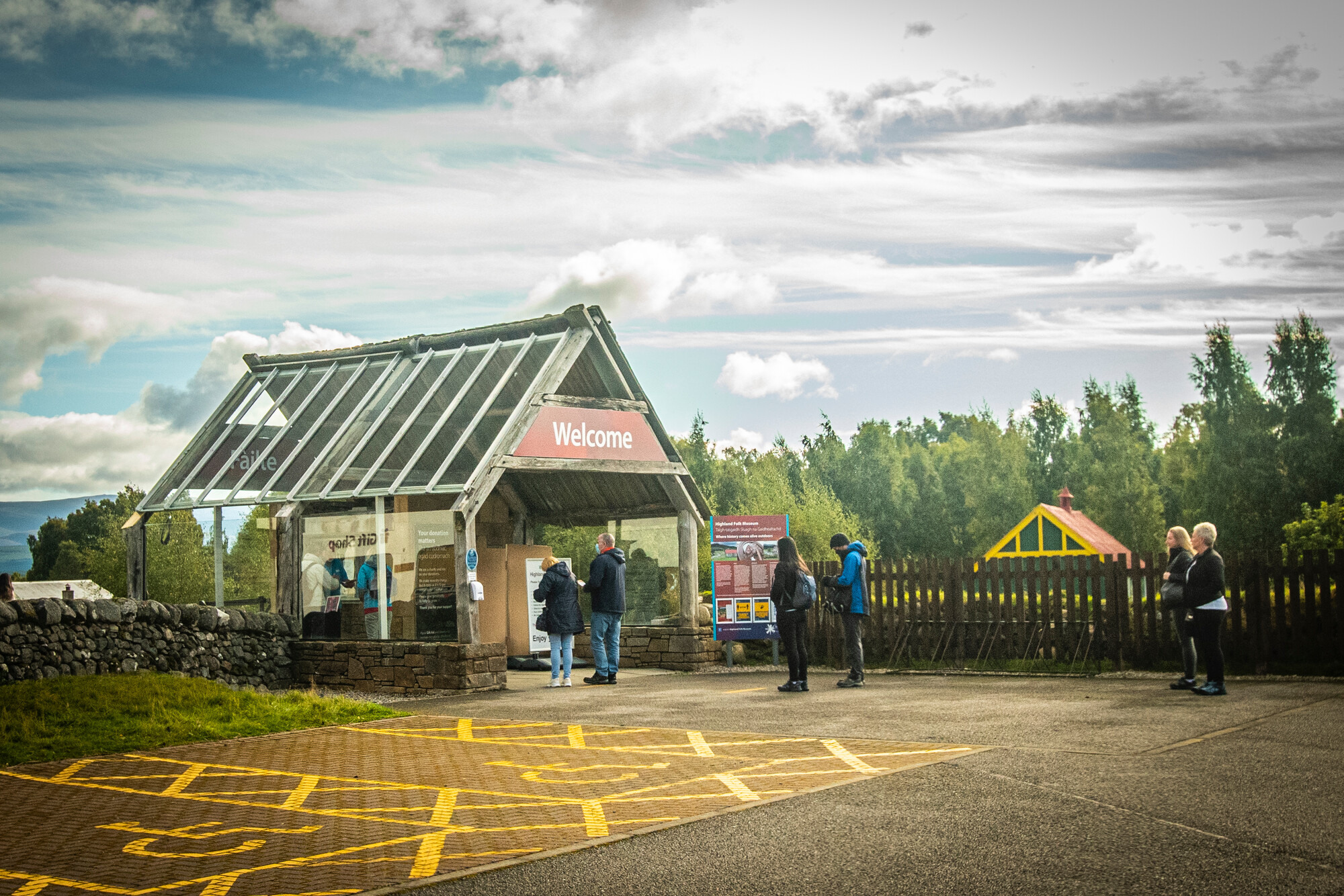 People standing outside the entrance to the Highland Folk Museum