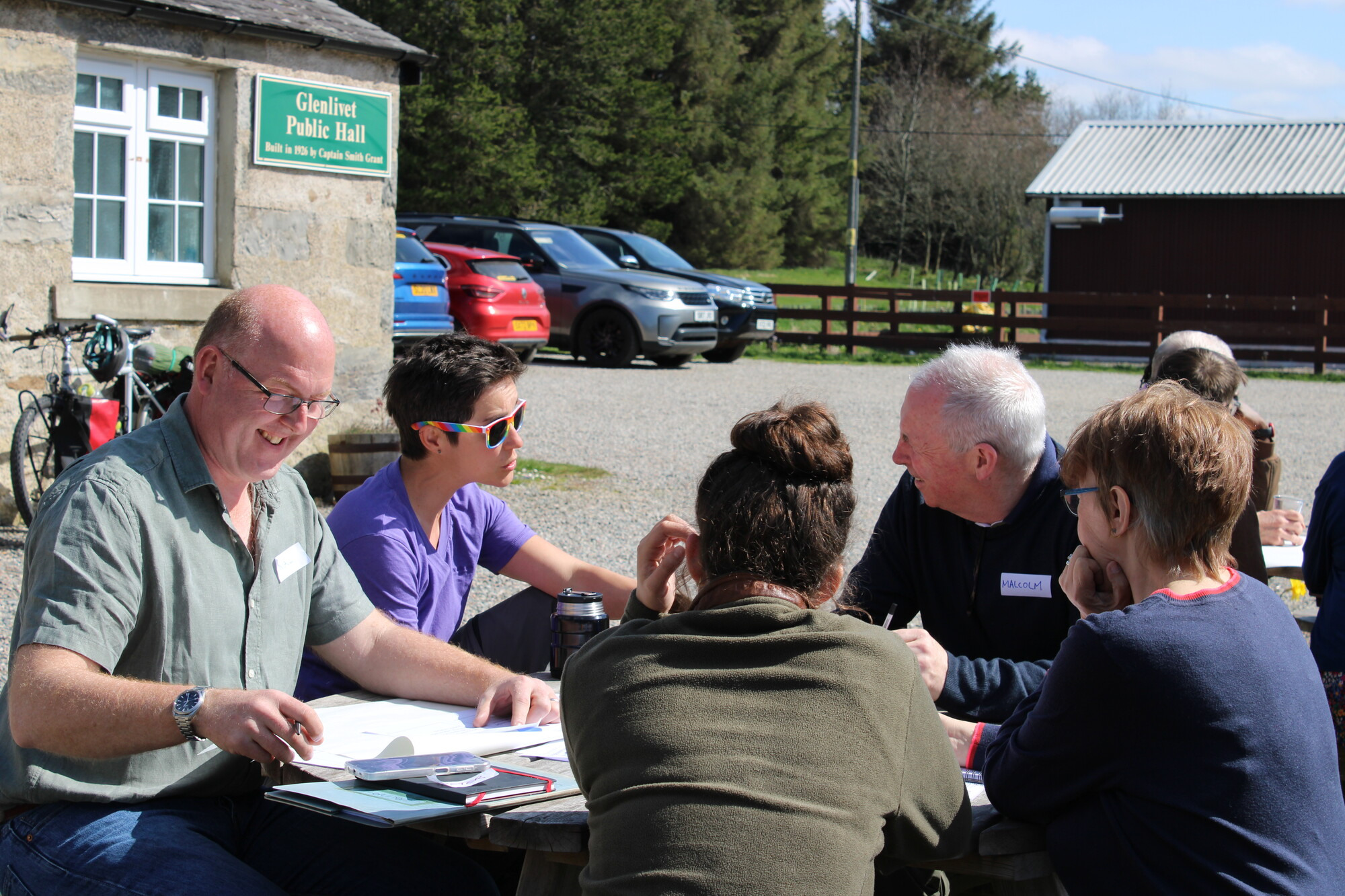 Members of the Cairngorms 2030 Communities Fund design panel sitting outside.