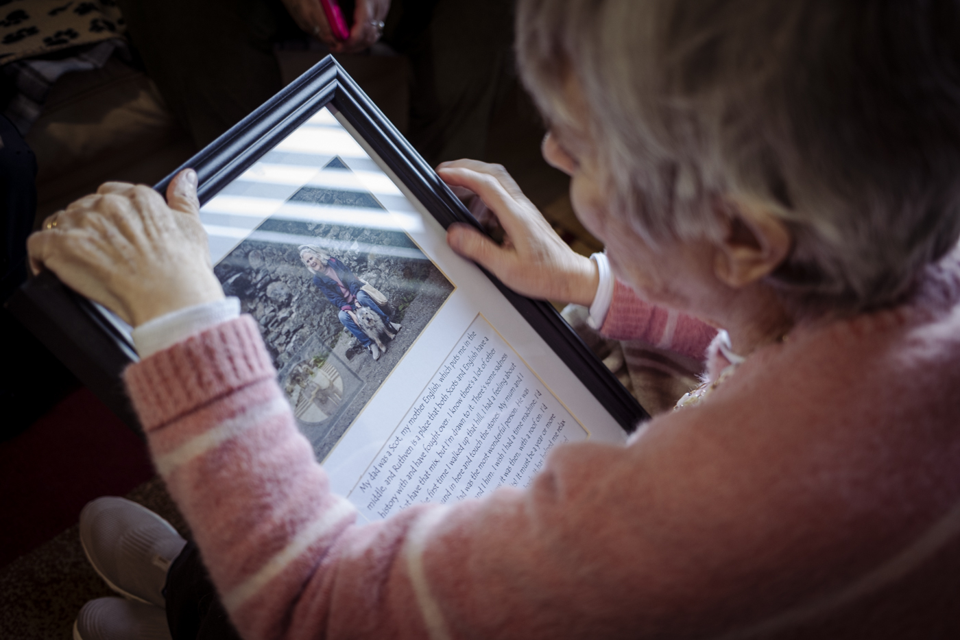Person looking at a framed picture.