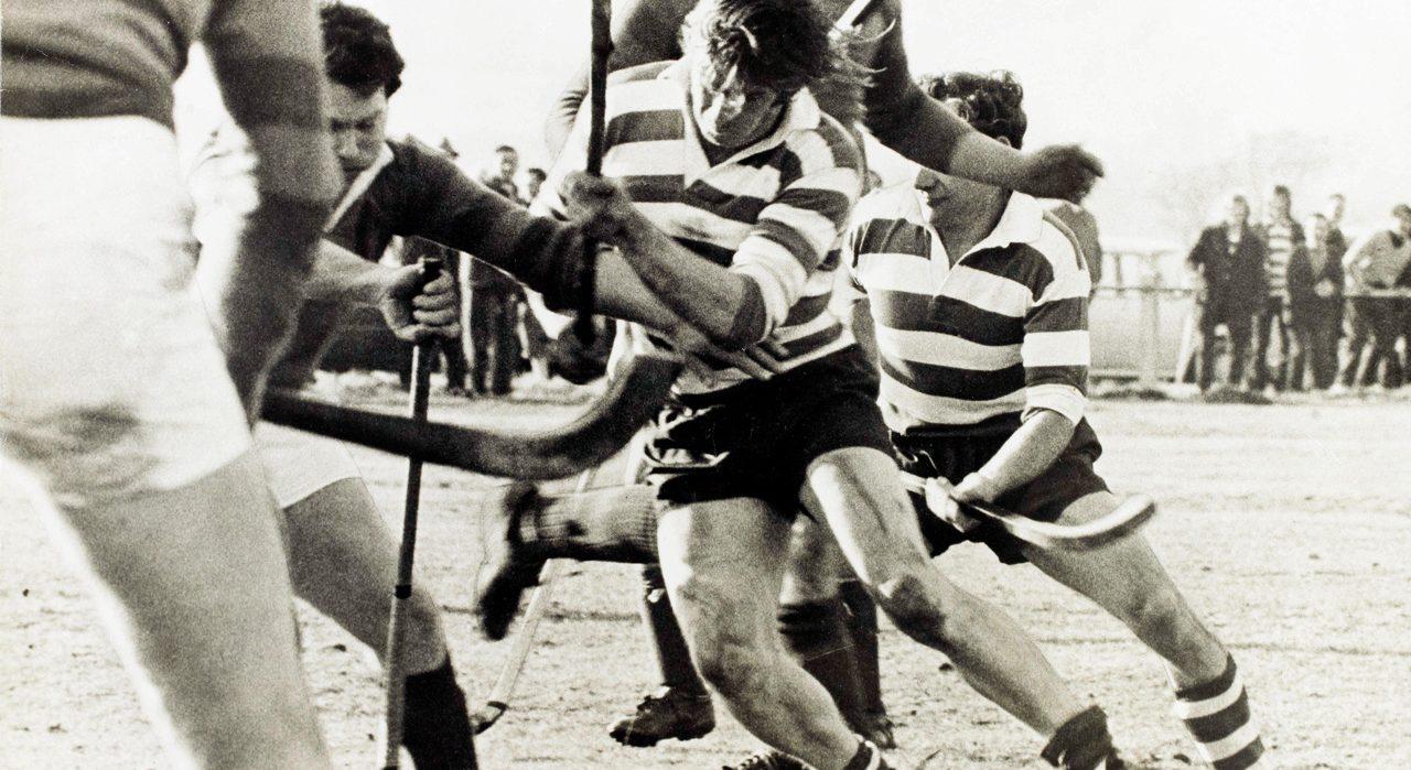 Black and white picture of a shinty game.
