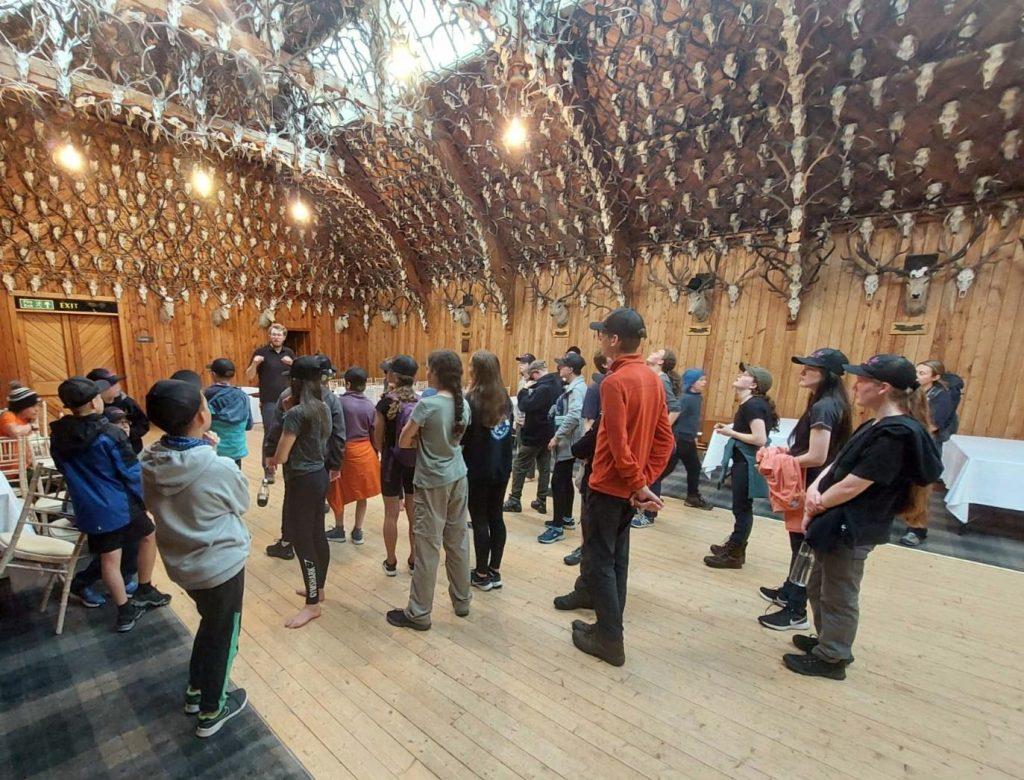 Mar Lodge Estate Seasonal Ranger Andrew was a junior ranger in the programme several years ago – here, he brings the 2022 camp to a close in the famous Mar Lodge ballroom.