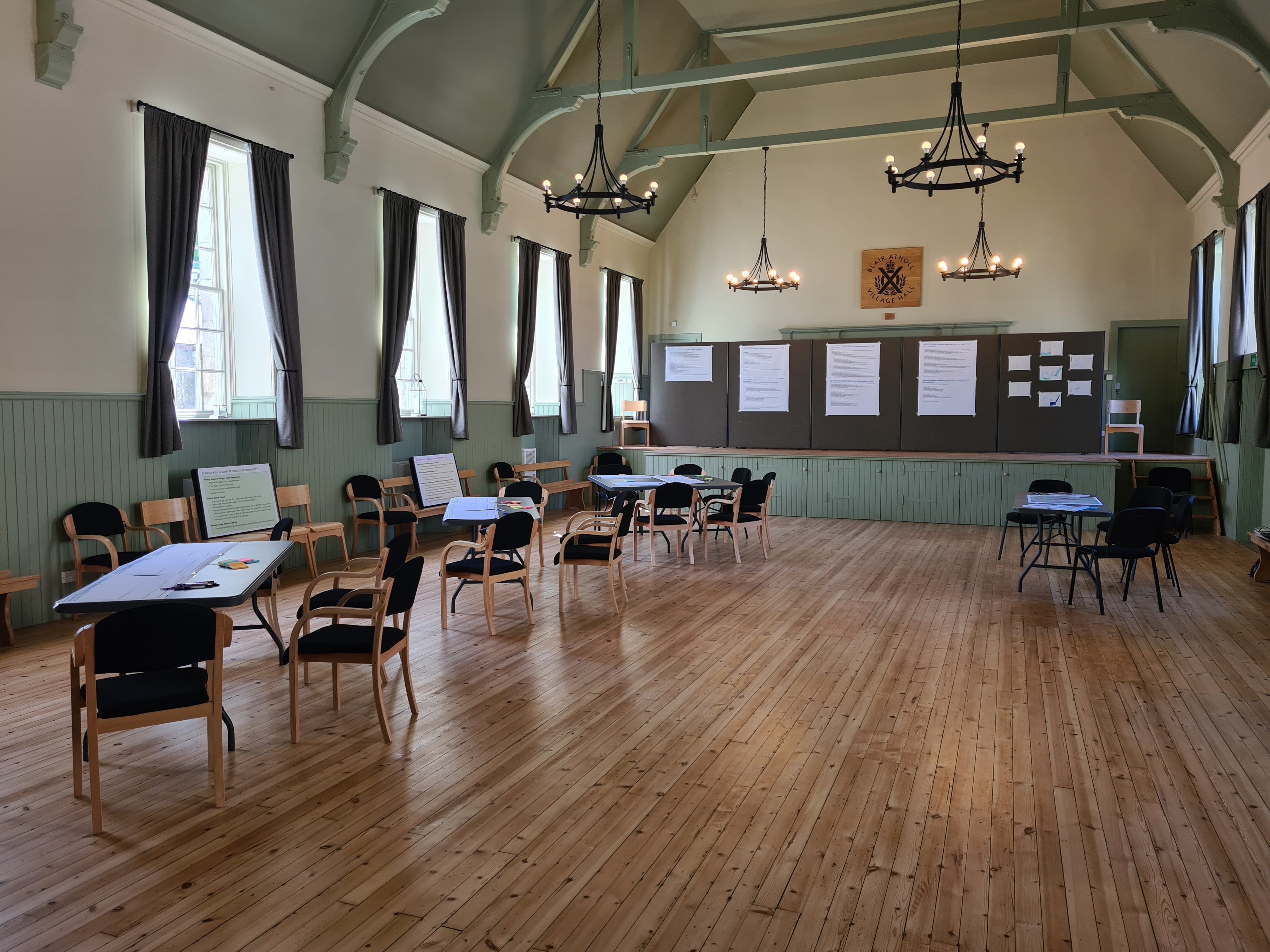Inside of a grand hall with empty chairs and tables