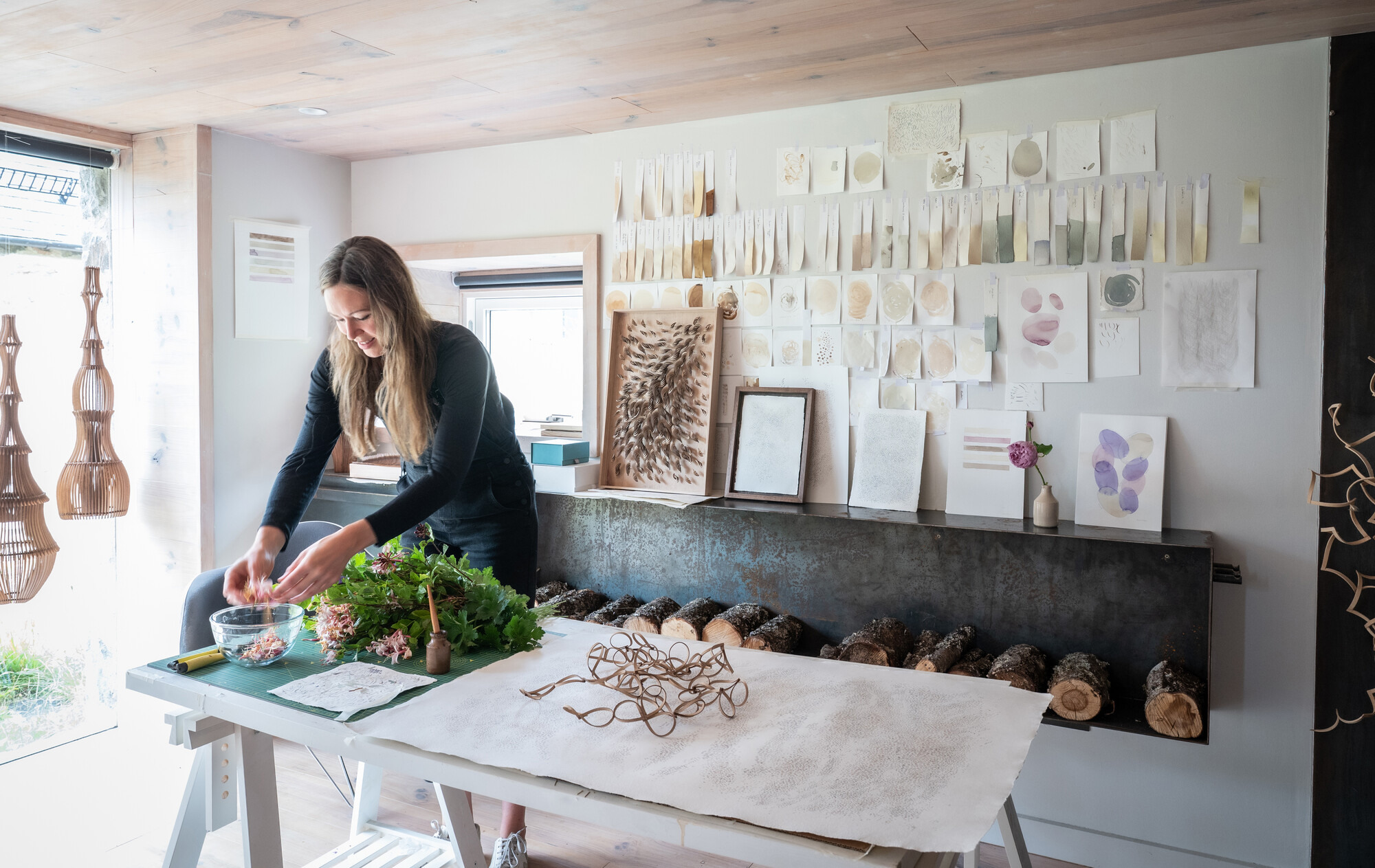 Artist in workshop arranging foliage