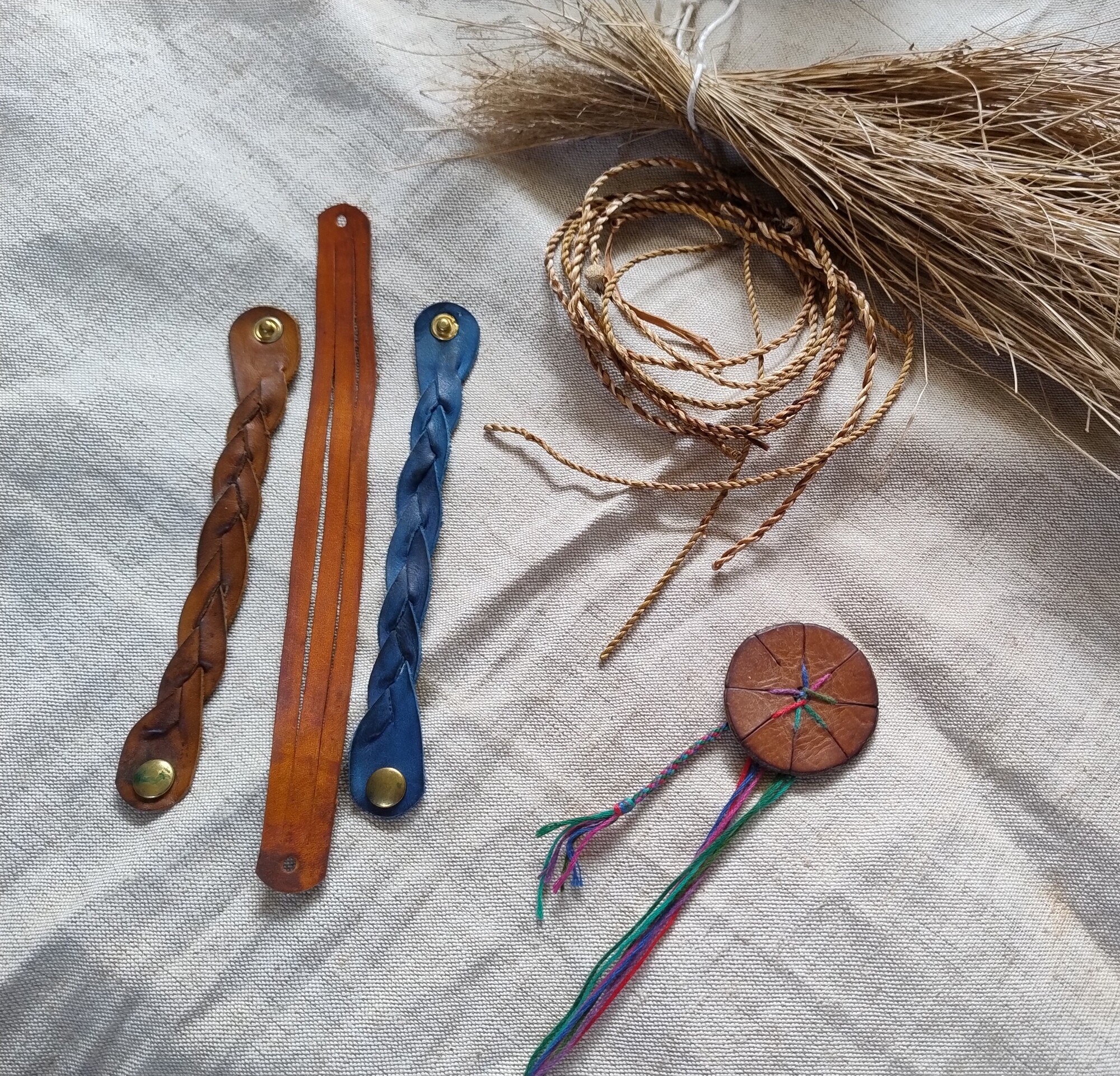 Braided leather items on cloth.