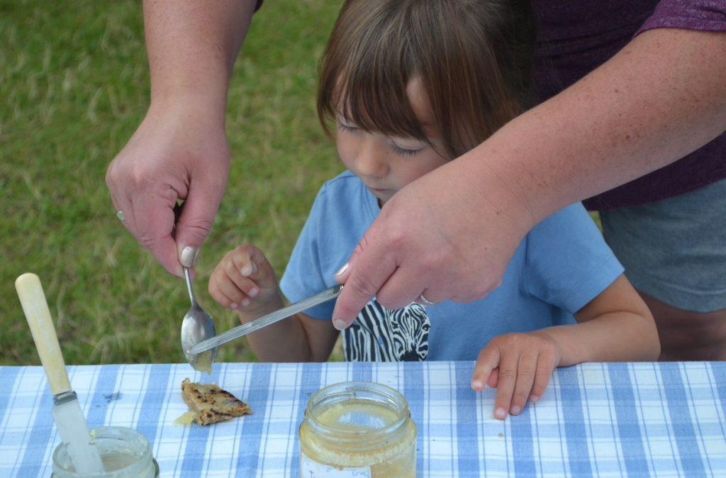 A girl preparing to eat her first bannock!