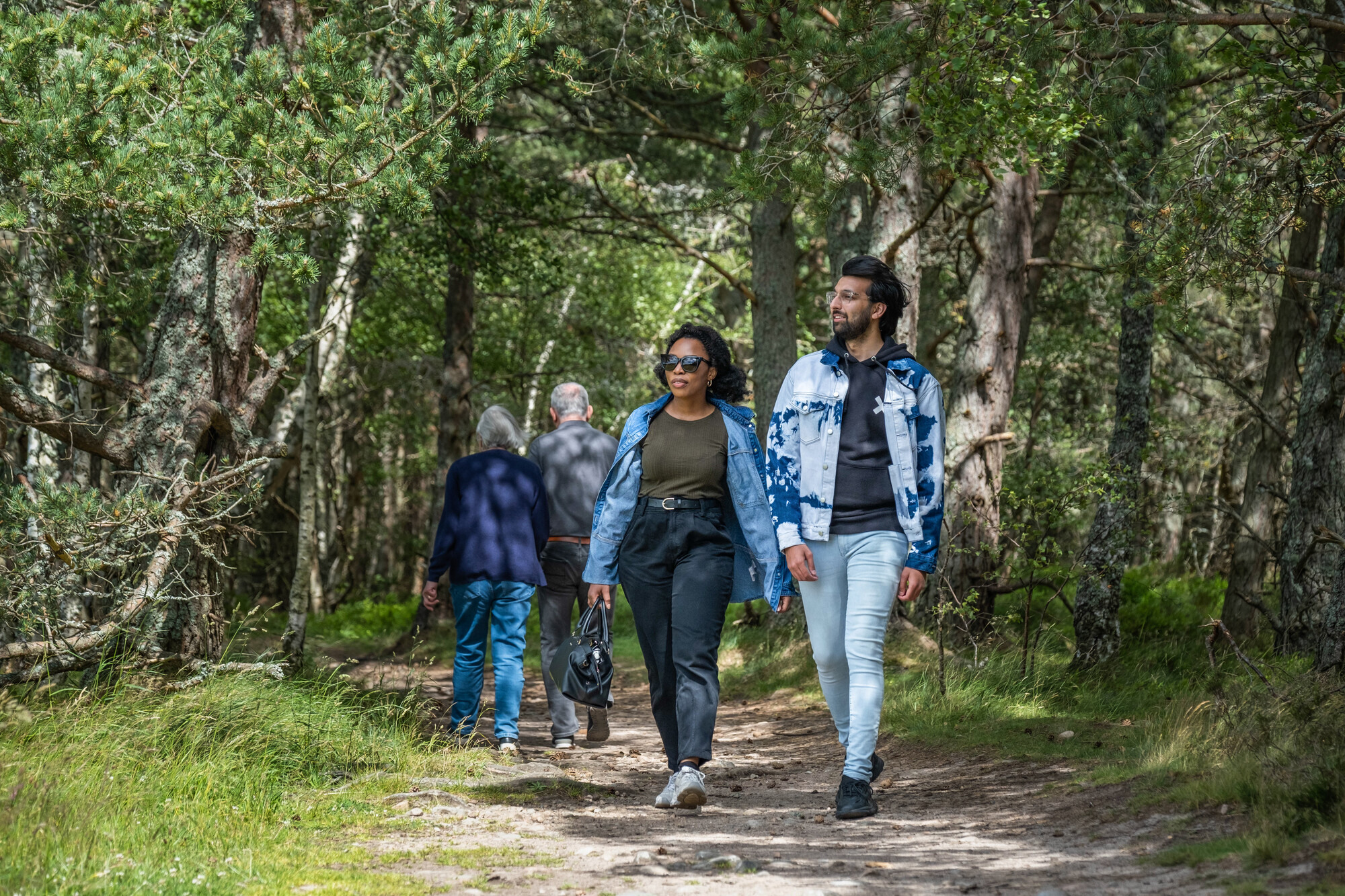People walking in a woodland area in Rothiemurchus