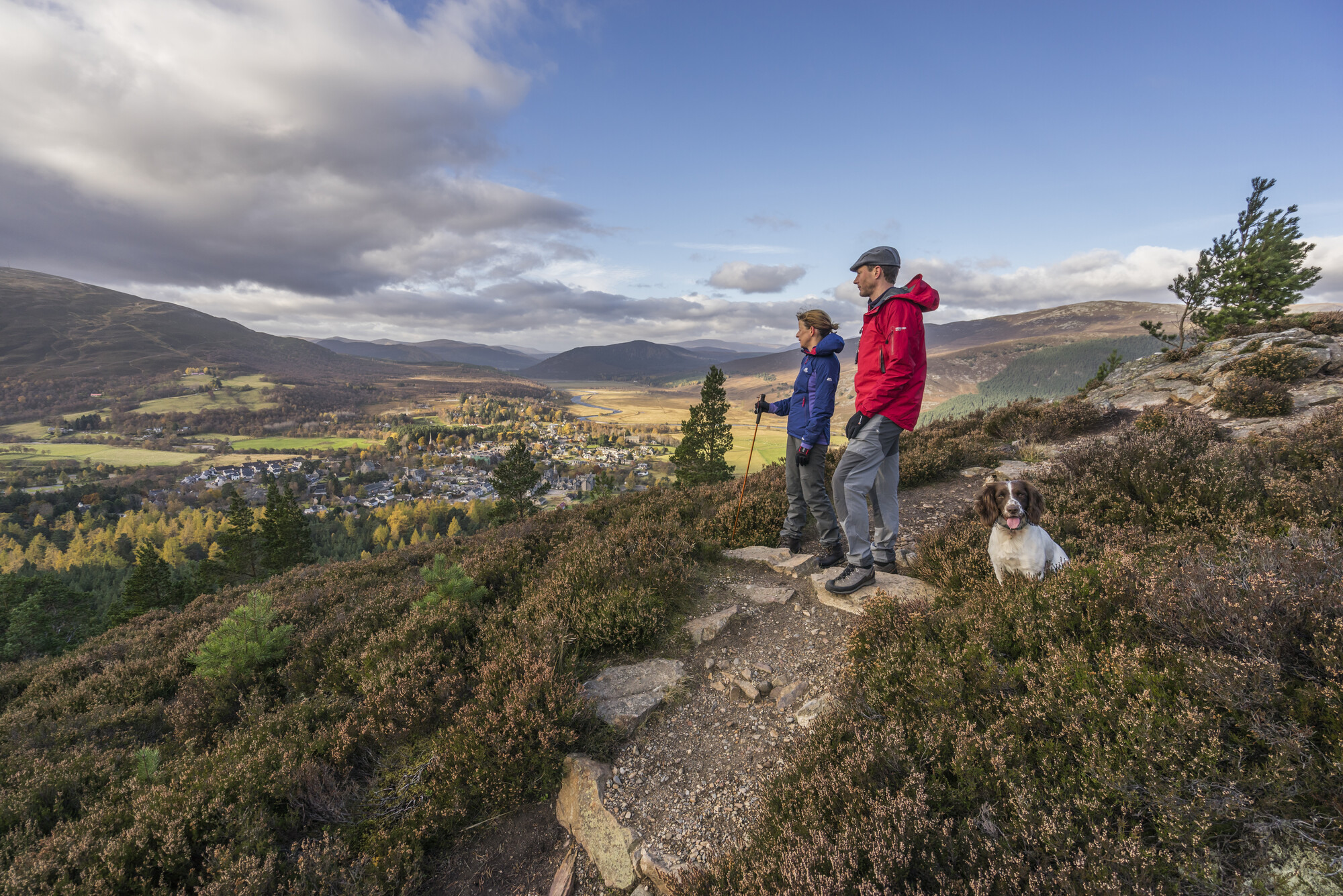 Two hillwalkers and their dogs enjoy the Braemar countryside
