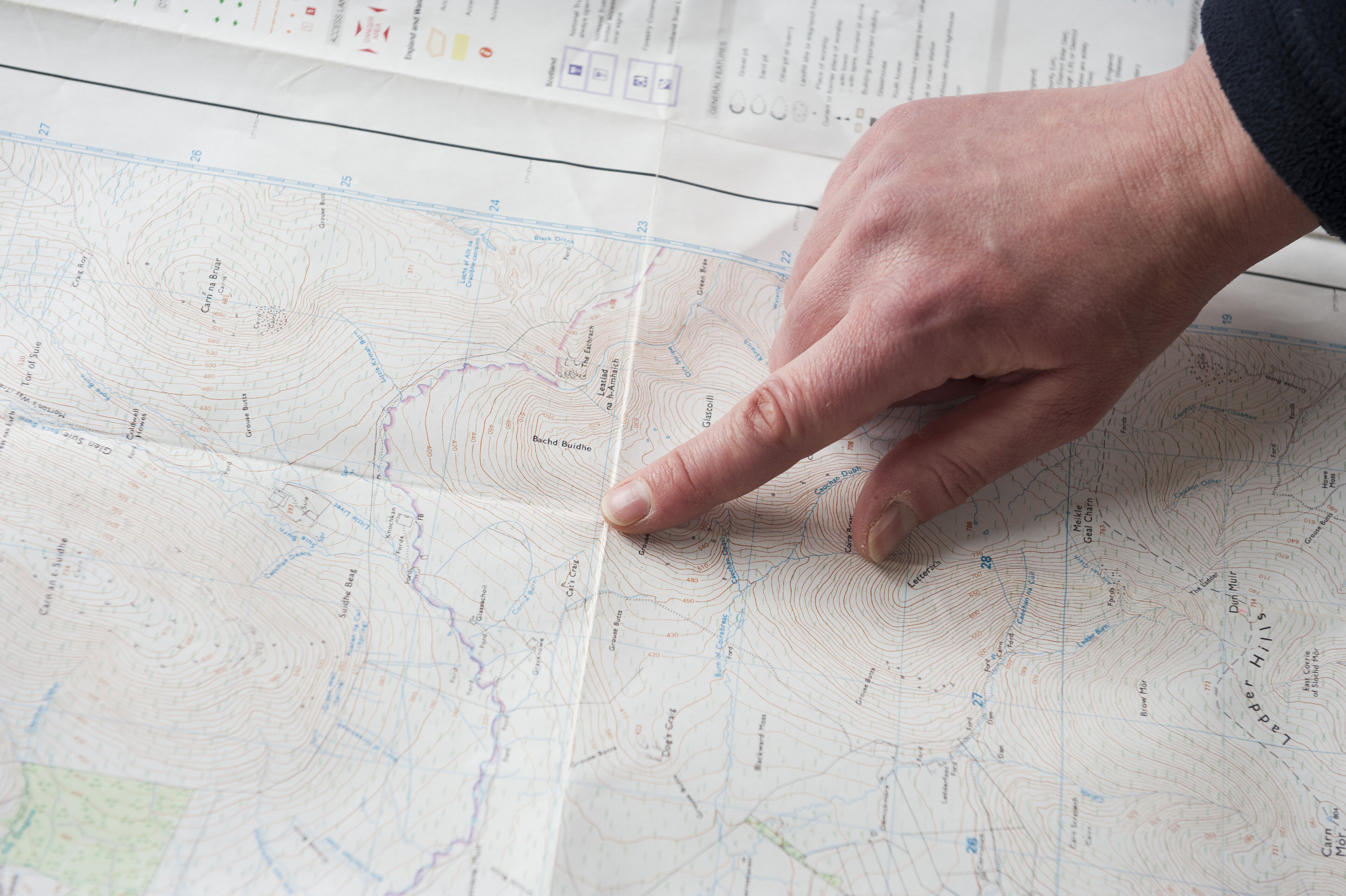 A hand, pointing at a map