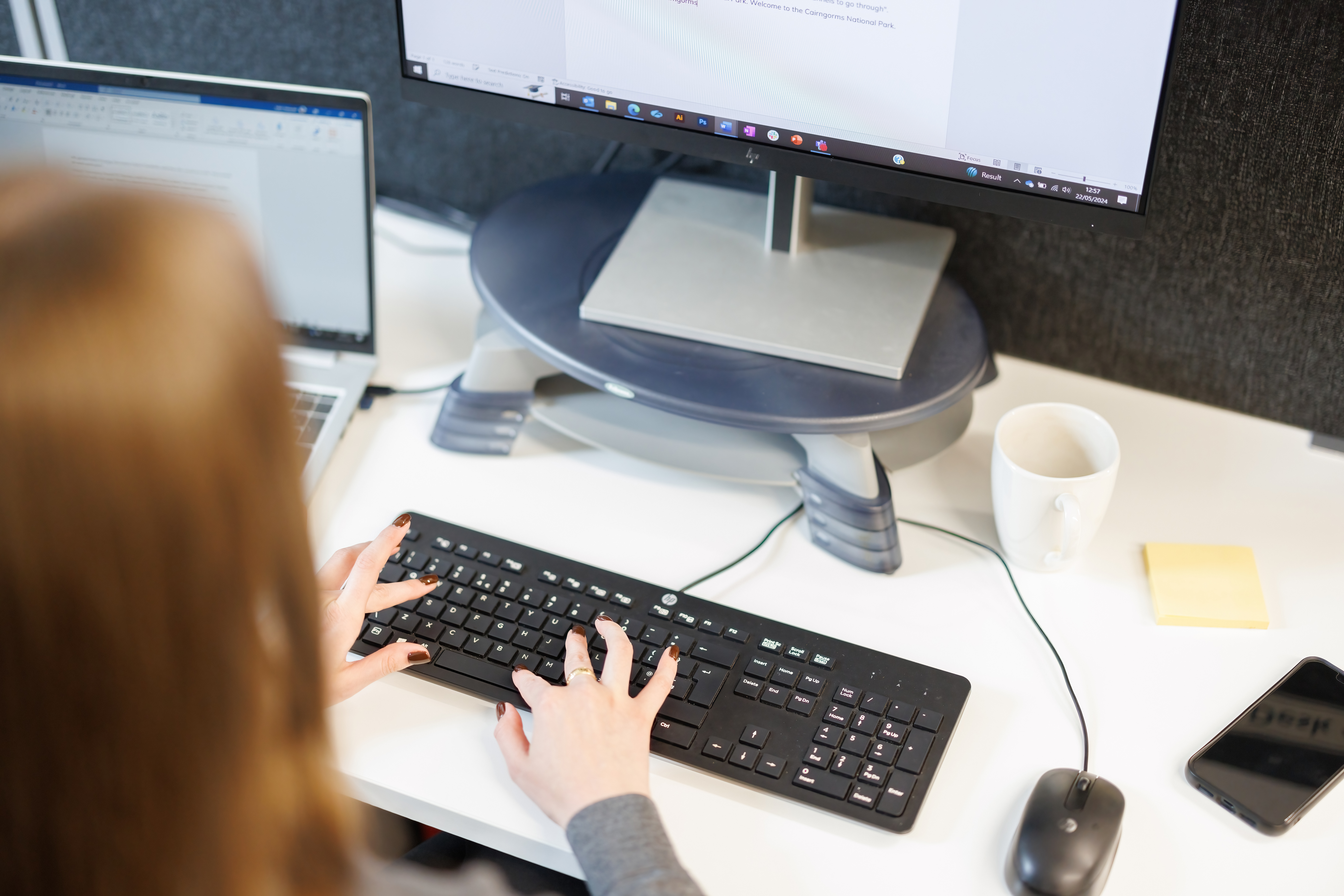 A person works at a computer in an office.