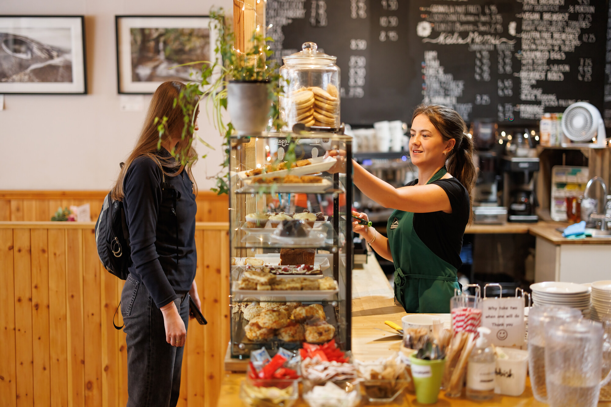 A person buys coffee and a cake in a café in the Cairngorms National Park