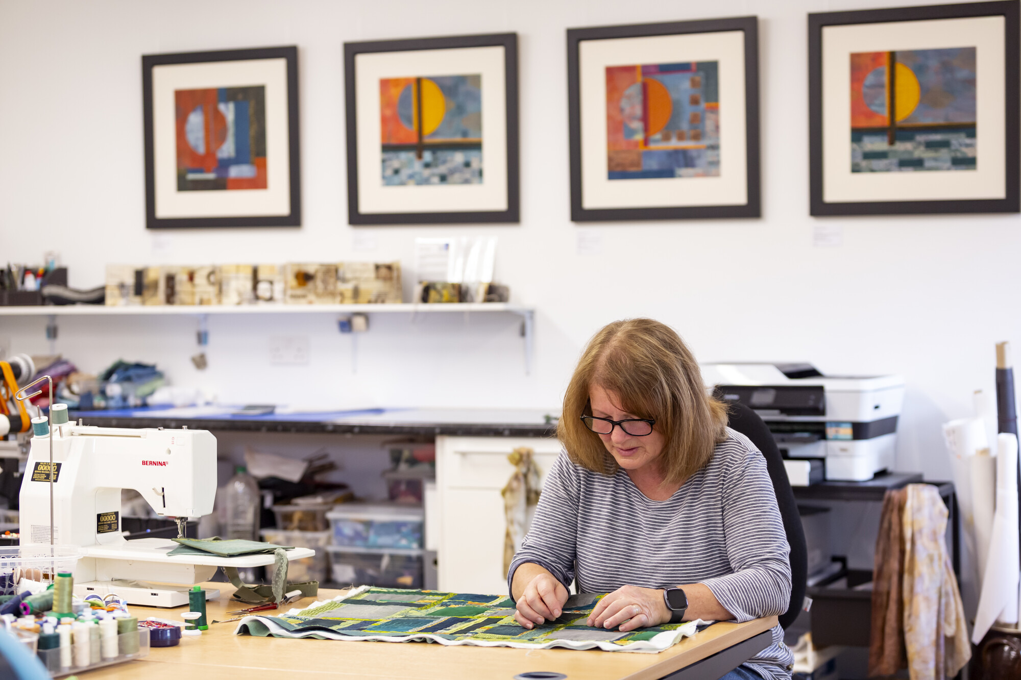 Artist Mahri Prince working on a piece of textile art in her studio