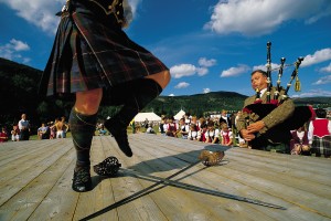 A PARTICIPANT TAKES PART IN THE SWORD DANCING EVENT WHILST A PIPER PROVIDES THE MUSICAL ACCOMPANIMENT AT THE BALLATER HIGHLAND GAMES, BALLATER- A VILLAGE ON THE RIVER DEE, EAST OF BRAEMAR, ABERDEENSHIRE. PIC: VisitScotland