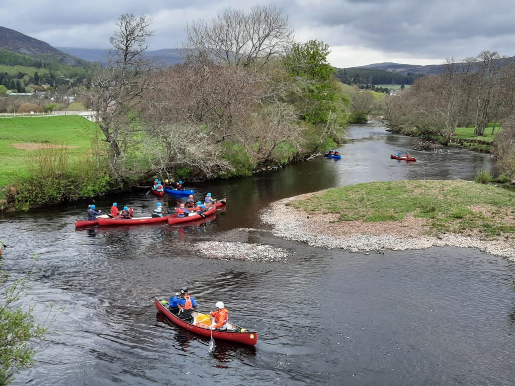 Children in canoes on the river spey