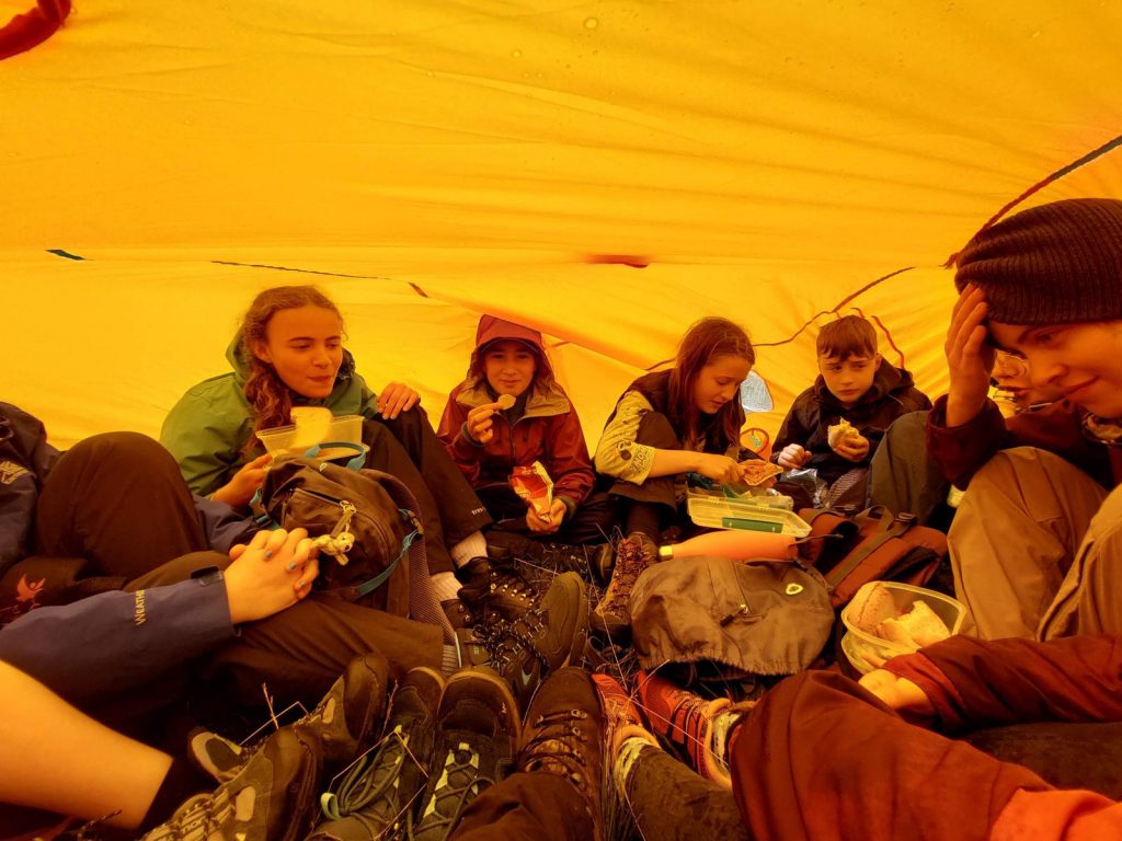 Junior rangers having a snack in a tent