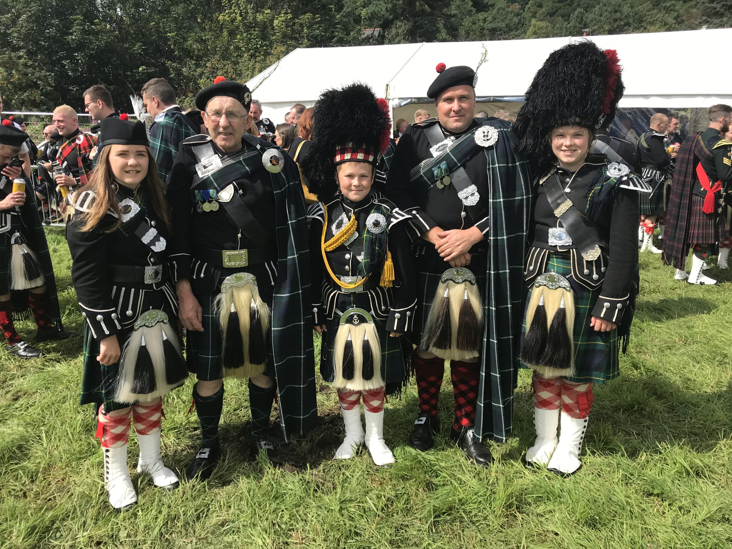 Five members of the Gordon family in highland dress at the Lonach Gathering 2023